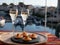 Russian style party with two glasses of white cold champagne, bliny with red caviar and view on Port Grimaud near Saint-Tropez in