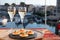 Russian style party with two glasses of white cold champagne, bliny with red caviar and view on Port Grimaud near Saint-Tropez in