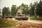 Russian tanks driving on a country road