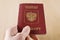 Russian Traveling Passport in hand.