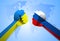 The Russian and Ukrainian flags on hands punch to each others on world map background.Ukraine crisis. Border conflict.