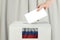 Russian Vote concept. Voter hand holding ballot paper for election vote on polling station