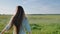 Russian young girl with a bouquet of flowers in her hands posing and running on a warm summer evening in the field.