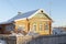 RussiaOld rural wooden house in russian village in winter sunny day. Moskow region, Russia