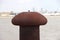 Rust-colored bollard for mooring ships in the port of Rotterdam in the netherlands