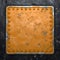 Rust metal with rivets in the shape of a square in the center on black metal background. 3d