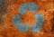 Rust stained corroded metal surfacewith recycling logo sign