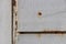 Rust White Painted Wall Texture Fragment. Screw