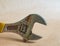 Rusted adjustable wrench isolated on vintage background.