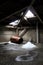 Rusted barrel and pile of snow on abandoned building attic