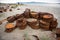 Rusted barrels on the shore.