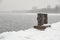 Rusted bollard on a snowy pier