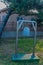 Rusted brass bell hanging from metal frame