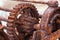 The rusted cogs and gears of a historic boat winch used on the F