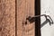 Rusted latch hook on rough wooden door