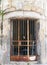 Rusted metal bars on the door of an old abandoned derelict building with cracked walls