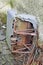 Rusted metal car seat with frayed fabric. Abandoned at the derelict Thornton Fever Hospital, Fife, Scotland