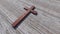 Rusted metal cross on a natural wood or wooden logg background. 3d illustration metaphor for God, Christ