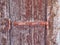 Rusted Metal Hinge on Flaking Wood Shutter