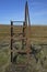 Rusted metal ladder stile over barbed wire fence in countryside