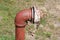 Rusted pipe in ground with chain