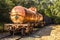 Rusted Railroad Tanker Car with Storage Cars Attached