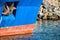 Rusted rugged Anchor on blue fishing ship