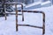 Rusted traffic bollards on a snowy street