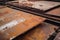 rusted and weathered aluminum sheets on a factory floor