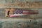 Rustic American flag handsaw on wood background