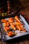 Rustic backed chicken wings,legs on baking tray