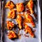 Rustic backed chicken wings,legs on baking tray