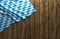 Rustic background for Oktoberfest with bavarian white and blue fabric on wooden - 3D rendering