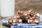 Rustic background with rocky road dessert squares with glass of