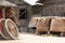 Rustic backyard with bamboo hut, baskets and two wooden wheels