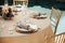 Rustic backyard wedding - reception tables with golden plates and chairs, dahlias, peonies and eucalyptus leaves and jute rope