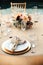 Rustic backyard wedding - reception tables with golden plates and chairs, dahlias, peonies and eucalyptus leaves and jute rope