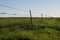 Rustic barbed wire fence around agricultural land