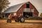 rustic barn with a vintage tractor parked nearby