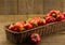 Rustic basket of red chili peppers on rough wood background