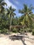 Rustic beach cabana and loungers on tropical beach