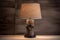 rustic bedside lamp with a metal base on linen