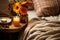 A rustic bedside table, a candle and a cozy blanket. Boho home decor. Ethnic bedroom interior. Generative AI