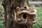 rustic birdhouse with natural twig ornamentation and squirrel feeder