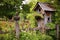 rustic birdhouse on old fence post in garden