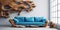 Rustic blue sofa near white wall with abstract massive wood root sculpture paneling. Eco interior design of modern room