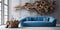 Rustic blue sofa near white wall with abstract massive wood root sculpture paneling. Eco interior design of modern room
