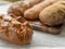 Rustic bread loaf with crust and loaves in background