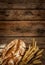 Rustic bread and wheat on vintage wood table