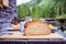 Rustic breakfast on an alpine hut: fresh crisp bread and milk in glass bottle, outdoors